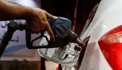 a worker holds a fuel nozzle to fills fuel in a car at petrol station in karachi on september 16 2023 photo reuters