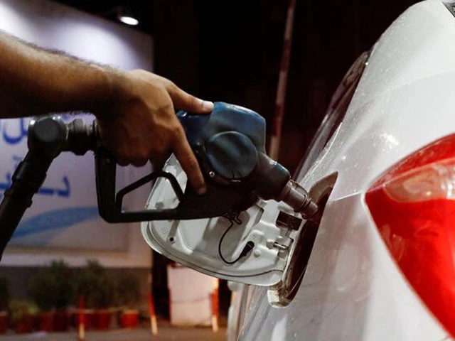a worker holds a fuel nozzle to fills fuel in a car at petrol station in karachi on september 16 2023 photo reuters