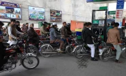 people wait for their turn to get fuel at a petrol station in peshawar photo reuters file