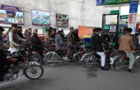 people wait for their turn to get fuel at a petrol station in peshawar on january 30 2023 photo reuters file