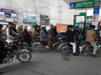 people wait for their turn to get fuel at a petrol station in peshawar on january 30 2023 photo reuters file