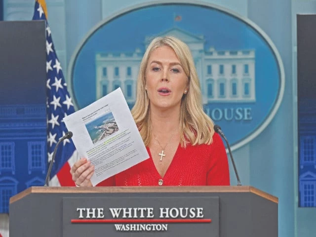 white house press secretary karoline leavitt holds up a reuters article on biden s gaza pier while answering a question during a press briefing at the white house in washington dc photo reuters