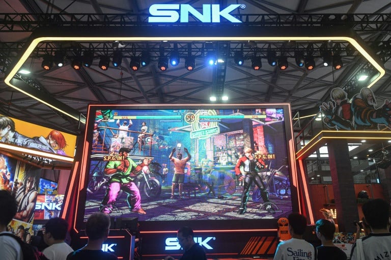 attendees visit the booth of japanese video game company snk at the annual chinajoy digital entertainment expo photo afp