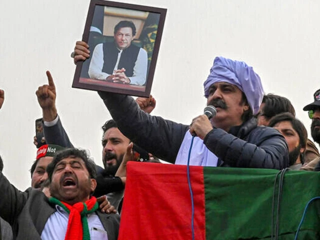 ali amin gandapur holds a portrait of former prime minister imran khan during a protest in peshawar on february 17 2024 photo afp