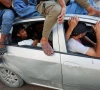 palestinian man hamas al hdabi mourns holding the body of his father sohail who was killed in an israeli strike as hamas sits inside a car during the funeral in gaza city july 16 2026 photo reuters