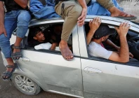 palestinian man hamas al hdabi mourns holding the body of his father sohail who was killed in an israeli strike as hamas sits inside a car during the funeral in gaza city july 16 2026 photo reuters