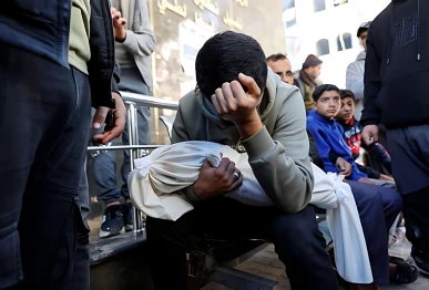 a palestinian man carries the body of his 5 month old brother ahmed al nader who was reportedly killed the previous day along with other family members in an israeli shelling on a school turned shelter in the tuffah neighbourhood of gaza city ahead of his funeral photo afp