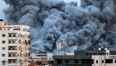 a plume of smoke rises above buildings in gaza city on october 7 2023 during an israeli air strike that hit the palestine tower building on the eve of the second anniversary of the october 7 2023 hamas attack that sparked the war delegations from hamas israel and the united states were due to convene in egypt for talks urged by us president donald trump to end the conflict photo afp