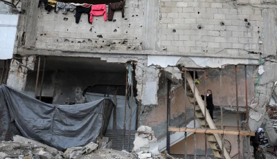 a palestinian girl climbs a wooden ladder at a residential building damaged during the war in gaza city december 14 2025 photo reuters