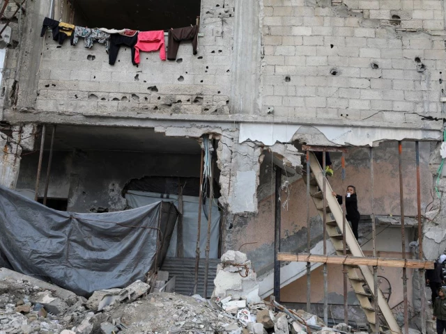 a palestinian girl climbs a wooden ladder at a residential building damaged during the war in gaza city december 14 2025 photo reuters a palestinian girl climbs a wooden ladder at a residential building damaged during the war in gaza city december 14 2025 photo reuters