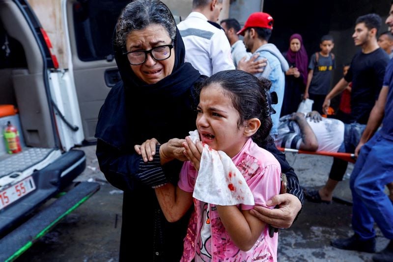 A Palestinian girl reacts in the aftermath of Israeli strikes, in Khan Younis in the southern Gaza Strip, October 14. PHOTO: REUTERS