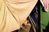 a child holds a blanket as displaced palestinians shelter in a tent camp in deir al balah central gaza strip january 19 2026 photo reuters
