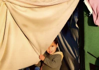 a child holds a blanket as displaced palestinians shelter in a tent camp in deir al balah central gaza strip january 19 2026 photo reuters