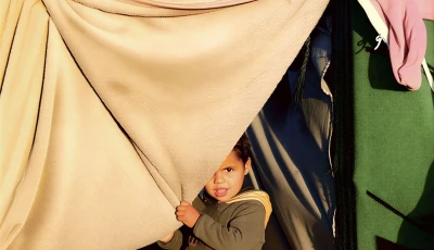 a child holds a blanket as displaced palestinians shelter in a tent camp in deir al balah central gaza strip january 19 2026 photo reuters