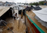 a displaced palestinian man clears muddy water in a flooded tent camp on a rainy day in nuseirat central gaza strip december 12 2025 photo reuters a displaced palestinian man clears muddy water in a flooded tent camp on a rainy day in nuseirat central gaza strip december 12 2025 photo reuters