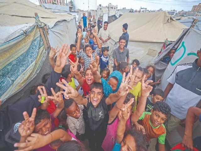palestinian children celebrate at a camp for displaced people in nuseirat in the central gaza strip following news of a new gaza ceasefire deal photo afp