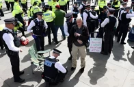 police officers detain a protester at everyone day a mass vigil and sign holding event in trafalgar square organised by defend our juries to demand the lifting of the ban on palestine action in london britain april 11 2026 photo reuters