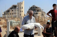 a relative carries the body of palestinian girl ameera al masri who was killed along with her parents and all three of her siblings in an israeli strike on their apartment in gaza city july 21 2026 reuters