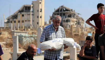 a relative carries the body of palestinian girl ameera al masri who was killed along with her parents and all three of her siblings in an israeli strike on their apartment in gaza city july 21 2026 reuters