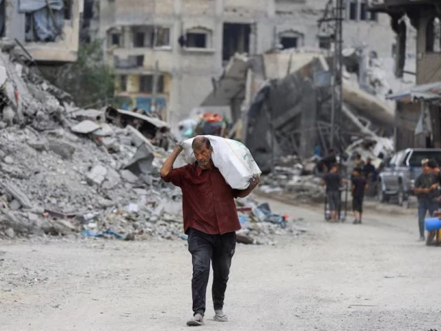 a palestinian man walks past rubble following the withdrawal of the israeli forces from the area amid a ceasefire between israel and hamas in gaza in gaza city october 12 2025 photo reuters