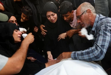 mourners react during the funeral of three palestinians including 10 year old tareq sabah who were killed in an israeli strike according to medics at nasser hospital in khan younis in the southern gaza strip july 1 2026 reuters