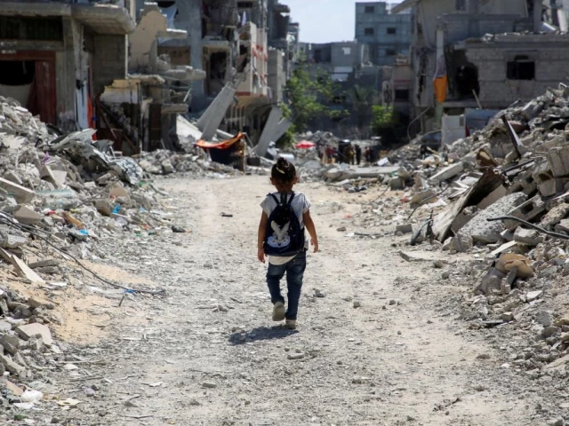 a girl is walking through demolished school in gaza photo reuters a girl is walking through demolished school in gaza photo reuters