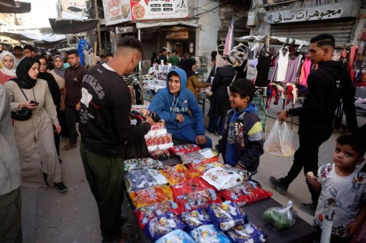 Palestinians shop on the eve of Eid Al-Adha in Khan Younis southern of Gaza Strip on May 26, 2026. PHOTO: AFP 