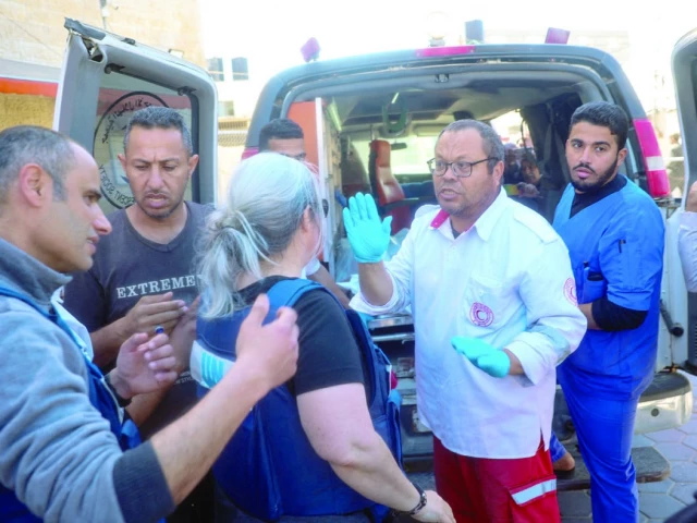 hospital staff transport the body of a foreign un worker in an ambulance in gaza photo afp hospital staff transport the body of a foreign un worker in an ambulance in gaza photo afp