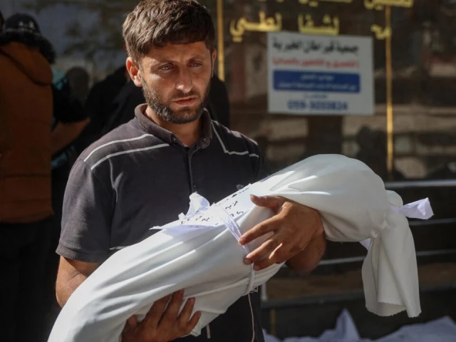 a man carries the shrouded body of a child killed during an israeli strike at al shifa hospital in gaza city on may 26 2025 rescuers said at least 33 people were killed mostly children and more than 60 wounded in an israeli strike on a school sheltering displaced people in gaza photo afp a man carries the shrouded body of a child killed during an israeli strike at al shifa hospital in gaza city on may 26 2025 rescuers said at least 33 people were killed mostly children and more than 60 wounded in an israeli strike on a school sheltering displaced people in gaza photo afp