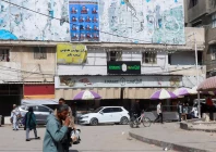 palestinians walk past an electoral candidates list displayed in deir al balah central gaza strip april 16 2026 photo reuters