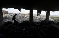 a palestinian man inspects the site of an israeli strike on a house whose residents were warned to evacuate before the attack near a tent camp sheltering displaced people that was damaged in the strike in khan younis in the southern gaza strip june 7 2026 reuters