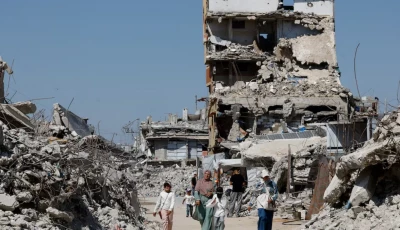 palestinians walk past the rubble of residential buildings destroyed during the war at jabalia refugee camp in the northern gaza strip august 5 2026 reuters