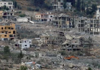 damaged and destroyed buildings are seen as israeli heavy machinery bulldozes houses in mansouri viewed from hinniyeh southern lebanon photo reuters