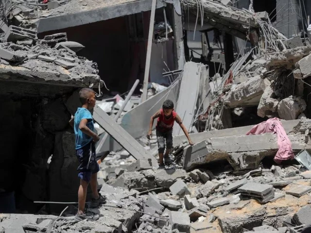 palestinian boys inspect the site of a morning israeli strike on a house in gaza city august 8 2025 photo reuters