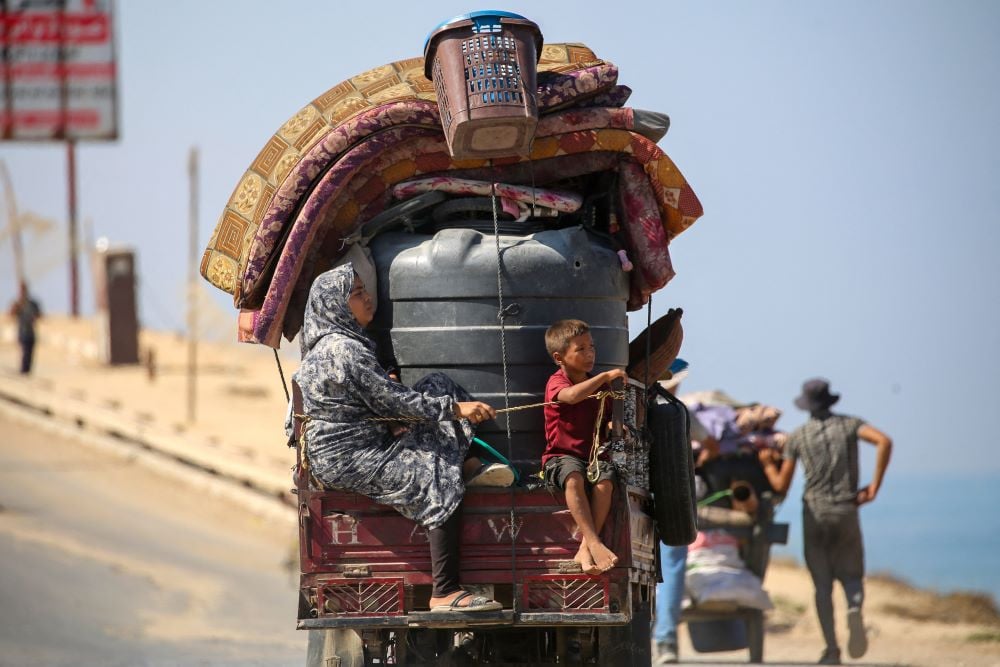 Palestinians transport their belongings as they evacuate Gaza City towards southern areas of the coastal Gaza Strip, on September 11, 2025. Israel's military said on September 9, it will act with 