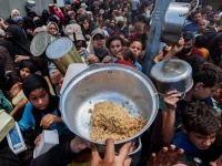 palestinians gather at a food distribution point in nuseirat refugee camp central gaza strip on 21 may 2025 as israel allows a limited amount of aid into the enclave photo reuters