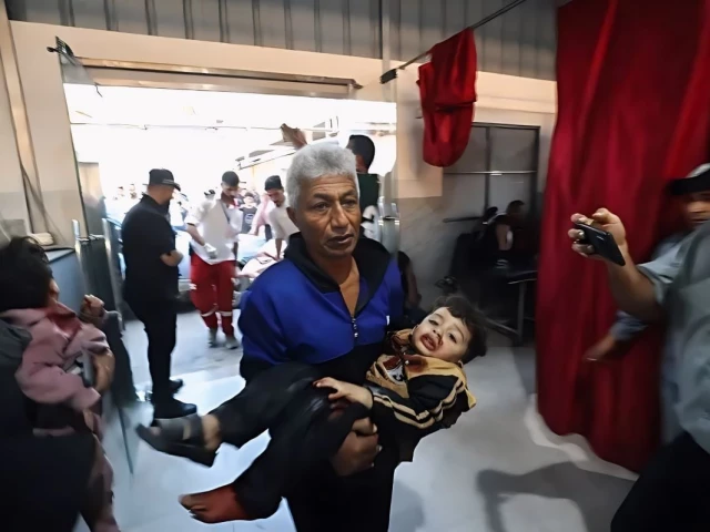 an injured child is brought to al awda hospital in central gaza after israeli bombardment on saturday photo afp