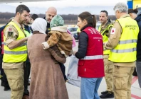 a woman and her baby arrive in geneva among 13 children and 51 family members moved from gaza under medical evacuations photo afp