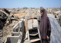 displaced a palestinian woman soumah dawla looks on as she stands on the rooftop of a house where she has taken shelter after being displaced due to the further advancement of the israeli military s yellow line in gaza city photo reuters