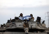 israeli soldiers hold an israeli flag while in a tank near israel s border with the gaza strip in southern israel october 12 2023 photo reuters