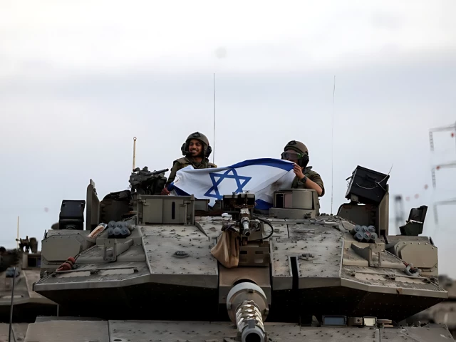israeli soldiers hold an israeli flag while in a tank near israel s border with the gaza strip in southern israel october 12 2023 photo reuters israeli soldiers hold an israeli flag while in a tank near israel s border with the gaza strip in southern israel october 12 2023 photo reuters