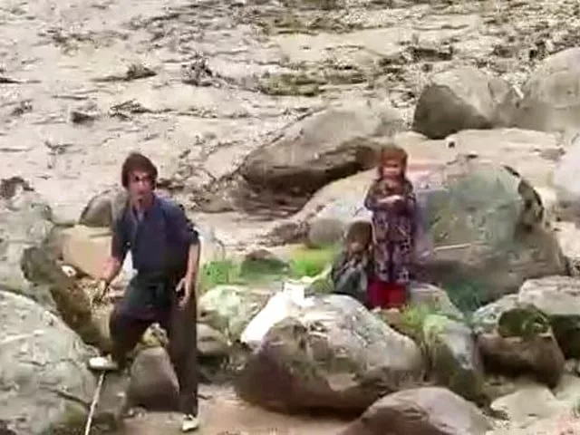 watch two youths brave gushing flood waters to save two minor girls in g b watch two youths brave gushing flood waters to save two minor girls in g b