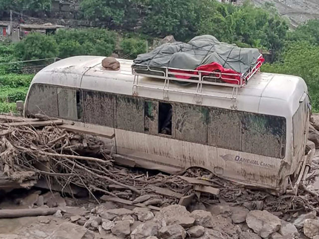 Stuck passenger van in the landslide hit area in Babusar, Gilgit-Baltistan region. Photo: AFP