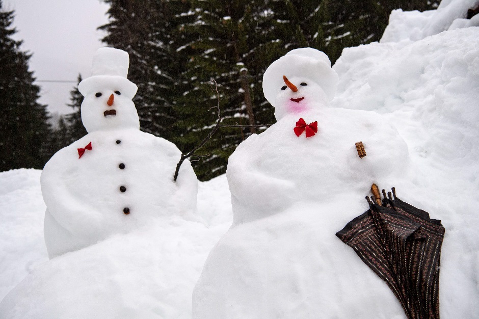 A snowman and a snow-woman with an umbrella stand in the rain in front of a house in Rottach-Egern, southern Germany. PHOTO: AFP