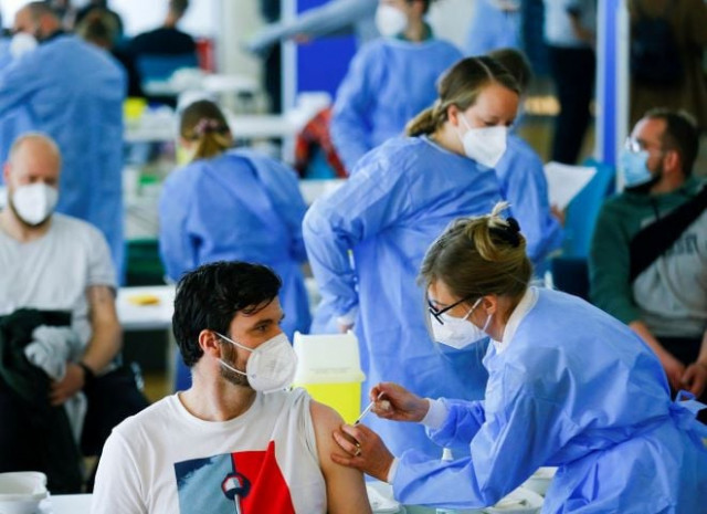 a man receives a dose of the astrazeneca covid 19 vaccine in the central mosque in ehrenfeld suburb amid the coronavirus disease covid 19 pandemic in cologne germany may 8 2021 reuters thilo schmuelgen
