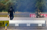 a police officer in protective clothing walks next to an explosive disarming robot eod at leipzig halle airport in schkeuditz germany august 5 2026 after the police said explosives experts examined a drone found near a runway and after a dhl cargo aircraft hit an unknown object as it was climbing away from the airport overnight prompting an unscheduled landing in hanover according to a source familiar with the incident reuters