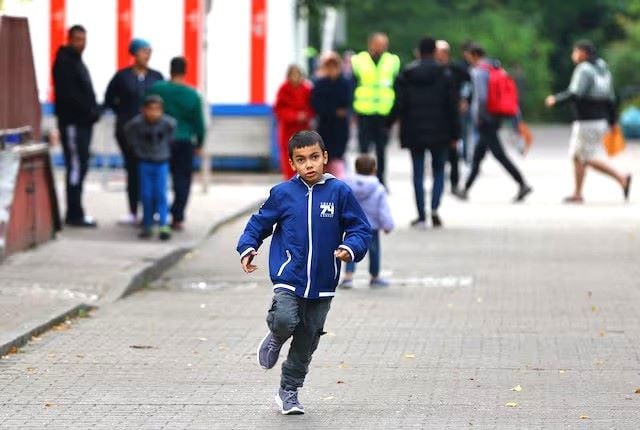 a boy runs outside the registration area for migrants at the arrival center for asylum seekers at berlin s reinickendorf district germany october 6 2023 photo reuters