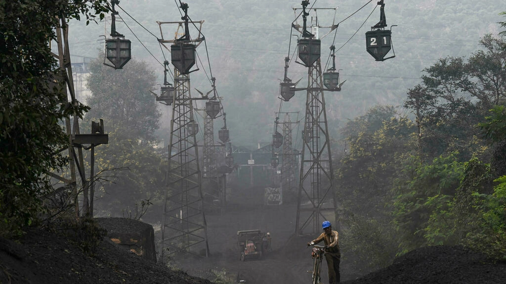 thick grey dust hangs in the air and vast chasms are gouged into the land in the indian coal hub of singrauli afp