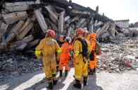 members of the 7th civil security training and intervention regiment exchange information with brazilian rescue workers next to a damaged building in catia la mar la guaira state venezuela june 29 reuters