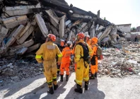 members of the 7th civil security training and intervention regiment exchange information with brazilian rescue workers next to a damaged building in catia la mar la guaira state venezuela june 29 reuters